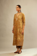 Mustard yellow silk velvet straight kurta set with delicate thread embroidery jaal all-over offset with bold gold dori embroidery at neck, sleeves and hem.