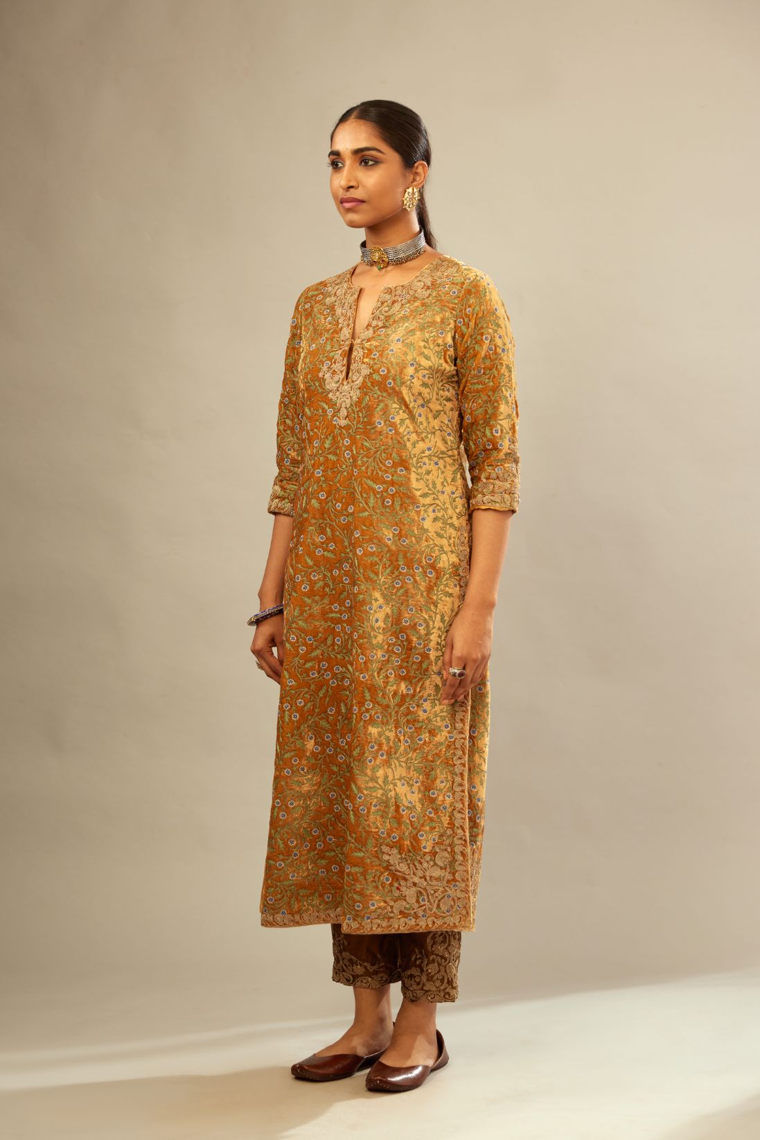 Mustard yellow silk velvet straight kurta set with delicate thread embroidery jaal all-over offset with bold gold dori embroidery at neck, sleeves and hem.