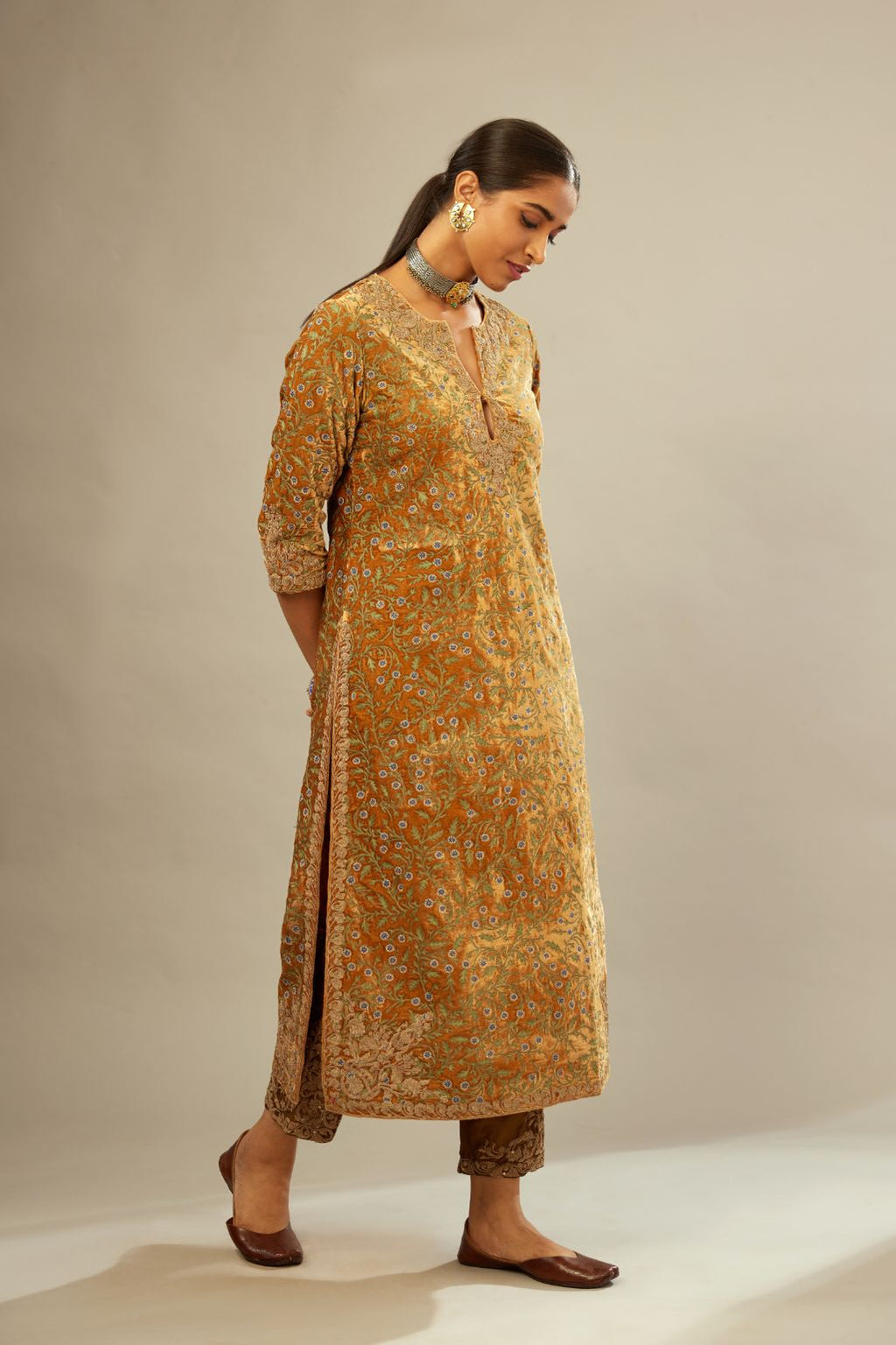 Mustard yellow silk velvet straight kurta set with delicate thread embroidery jaal all-over offset with bold gold dori embroidery at neck, sleeves and hem.