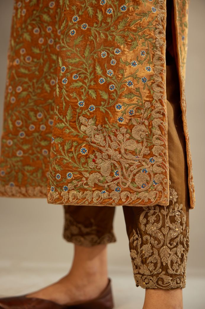 Mustard yellow silk velvet straight kurta set with delicate thread embroidery jaal all-over offset with bold gold dori embroidery at neck, sleeves and hem.