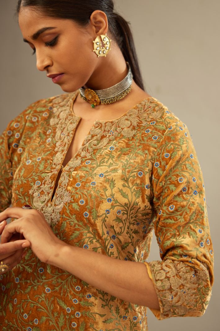 Mustard yellow silk velvet straight kurta set with delicate thread embroidery jaal all-over offset with bold gold dori embroidery at neck, sleeves and hem.