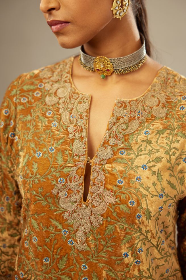 Mustard yellow silk velvet straight kurta set with delicate thread embroidery jaal all-over offset with bold gold dori embroidery at neck, sleeves and hem.