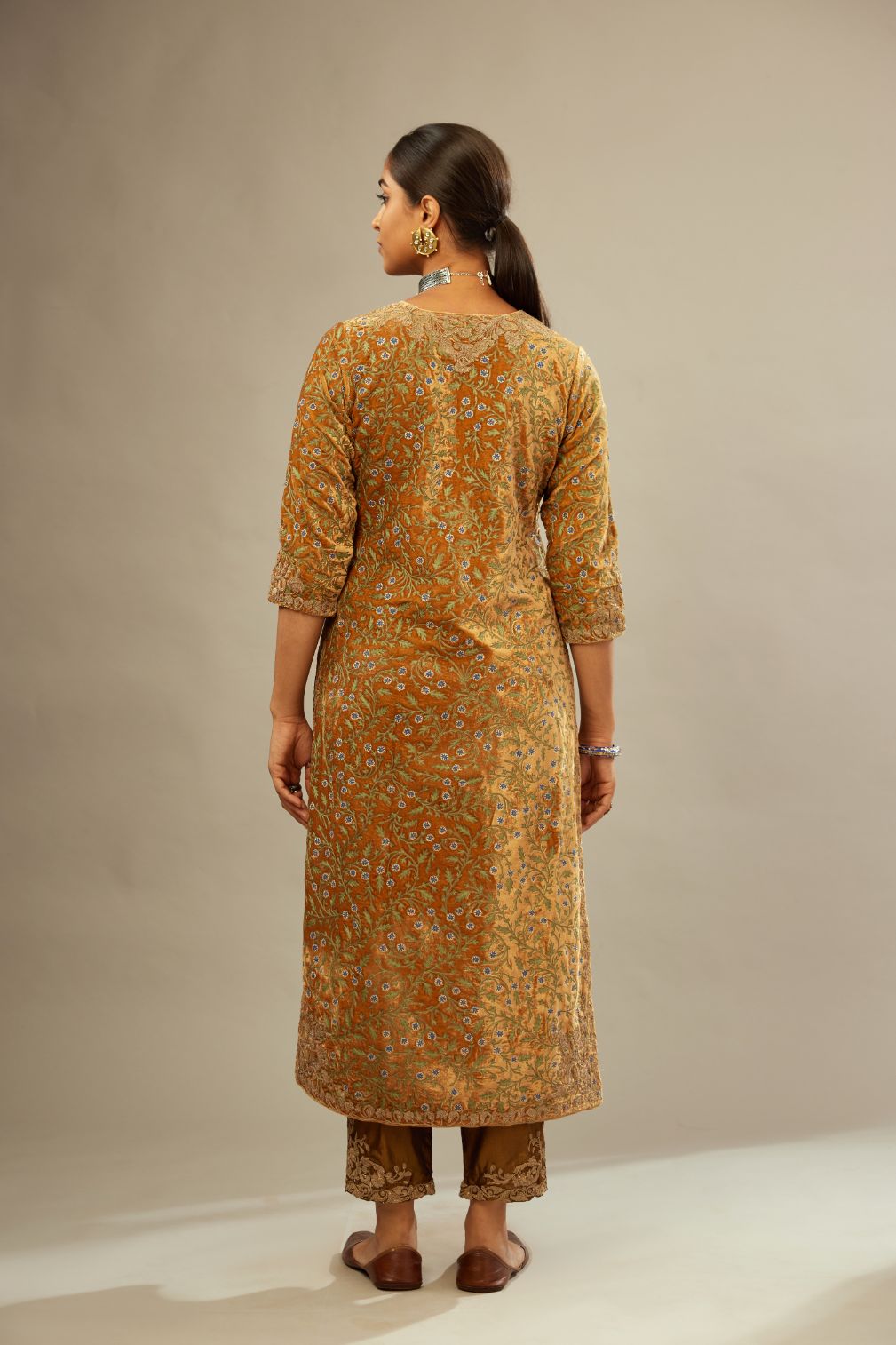 Mustard yellow silk velvet straight kurta set with delicate thread embroidery jaal all-over offset with bold gold dori embroidery at neck, sleeves and hem.