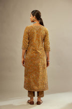 Mustard yellow silk velvet straight kurta set with delicate thread embroidery jaal all-over offset with bold gold dori embroidery at neck, sleeves and hem.