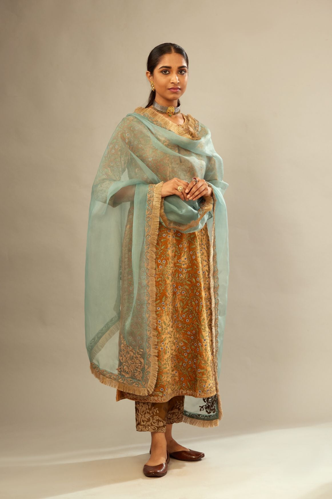 Mustard yellow silk velvet straight kurta set with delicate thread embroidery jaal all-over offset with bold gold dori embroidery at neck, sleeves and hem.