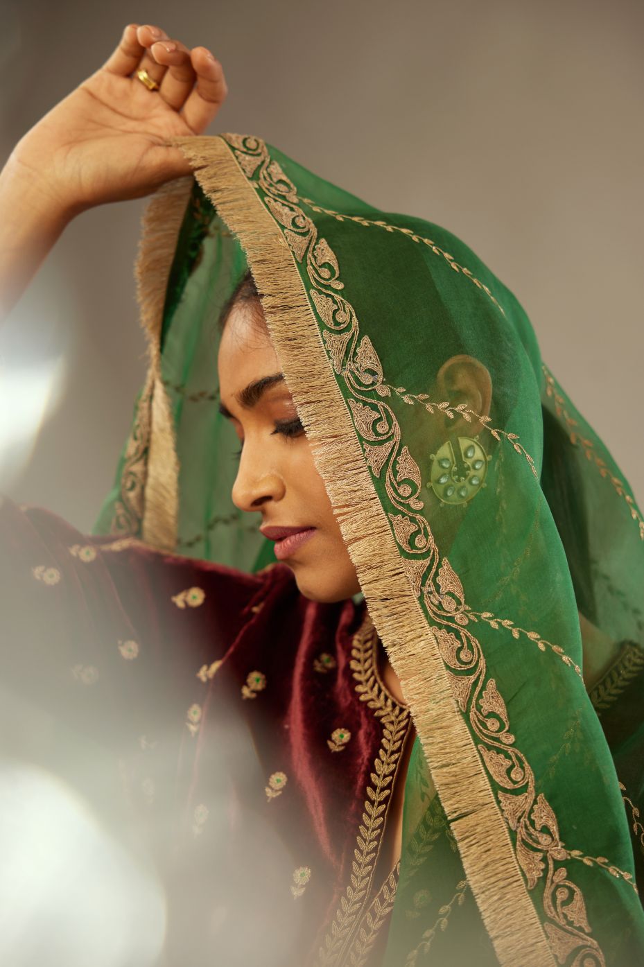 Dark green silk organza dupatta with dori embroidery border at the edges and diagonal zari embroidered lines all-over the dupatta.