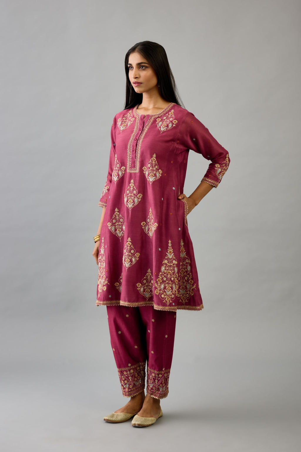 Wine silk chanderi short kalidar phiran style kurta set with dori and contrast silk thread embroidery, highlighted with gold sequins work.