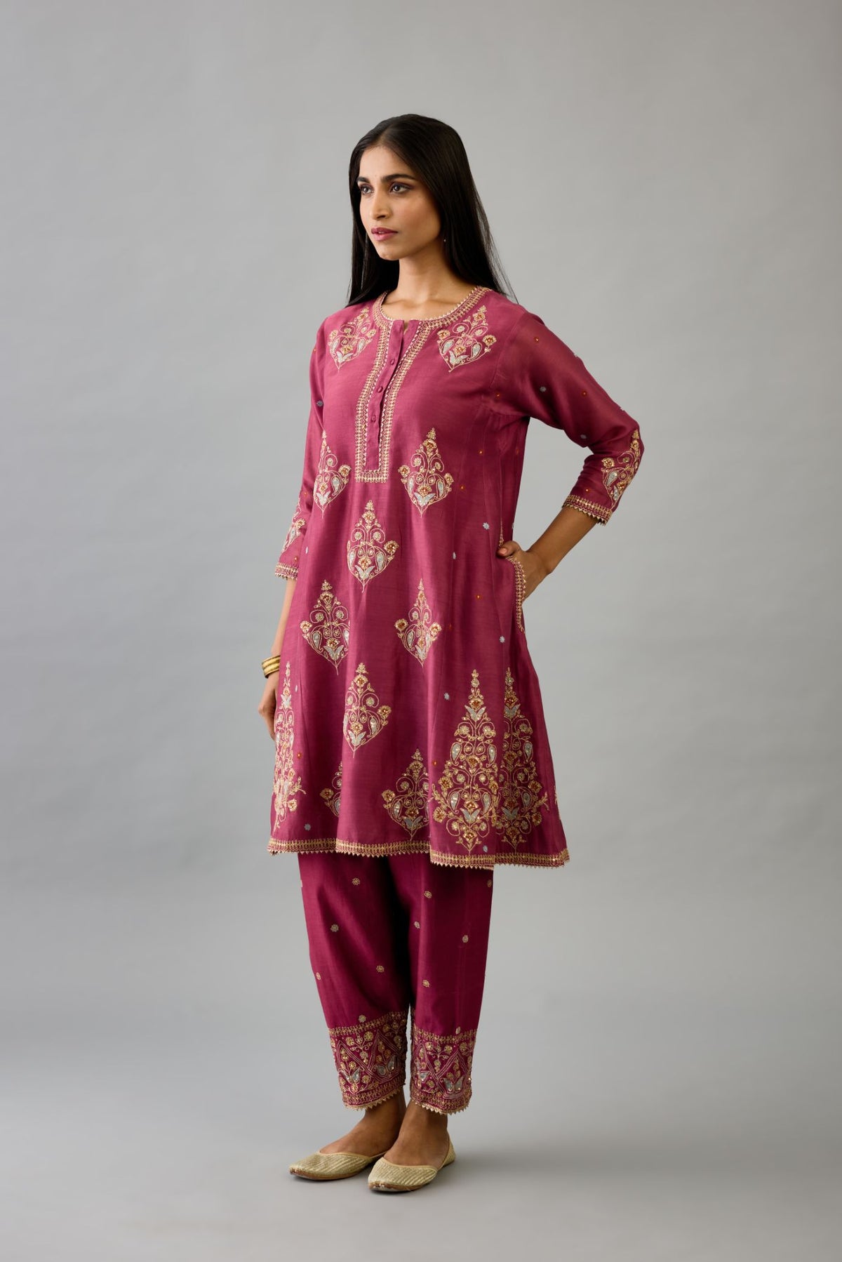 Wine silk chanderi short kalidar phiran style kurta set with dori and contrast silk thread embroidery, highlighted with gold sequins work.