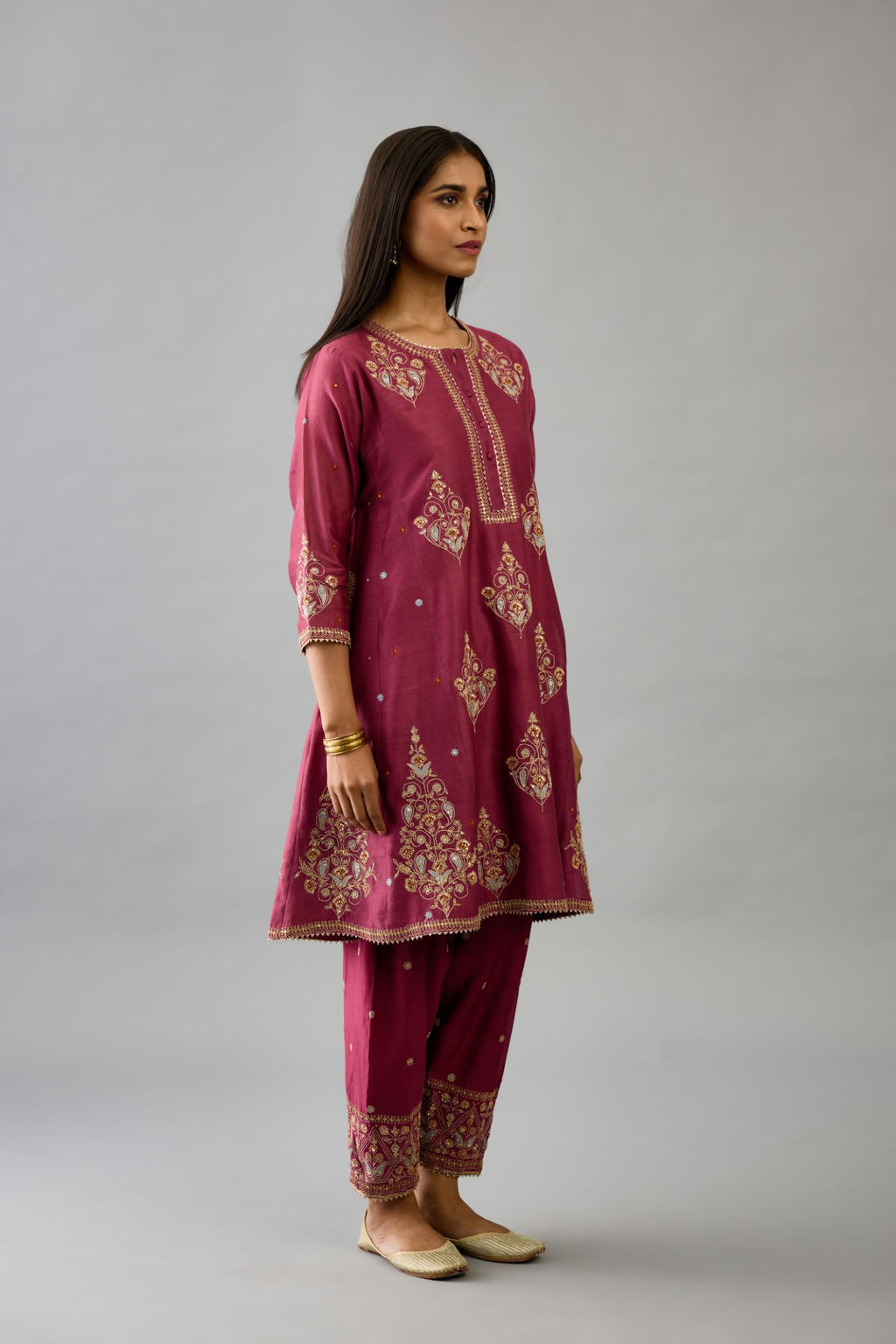 Wine silk chanderi short kalidar phiran style kurta set with dori and contrast silk thread embroidery, highlighted with gold sequins work.