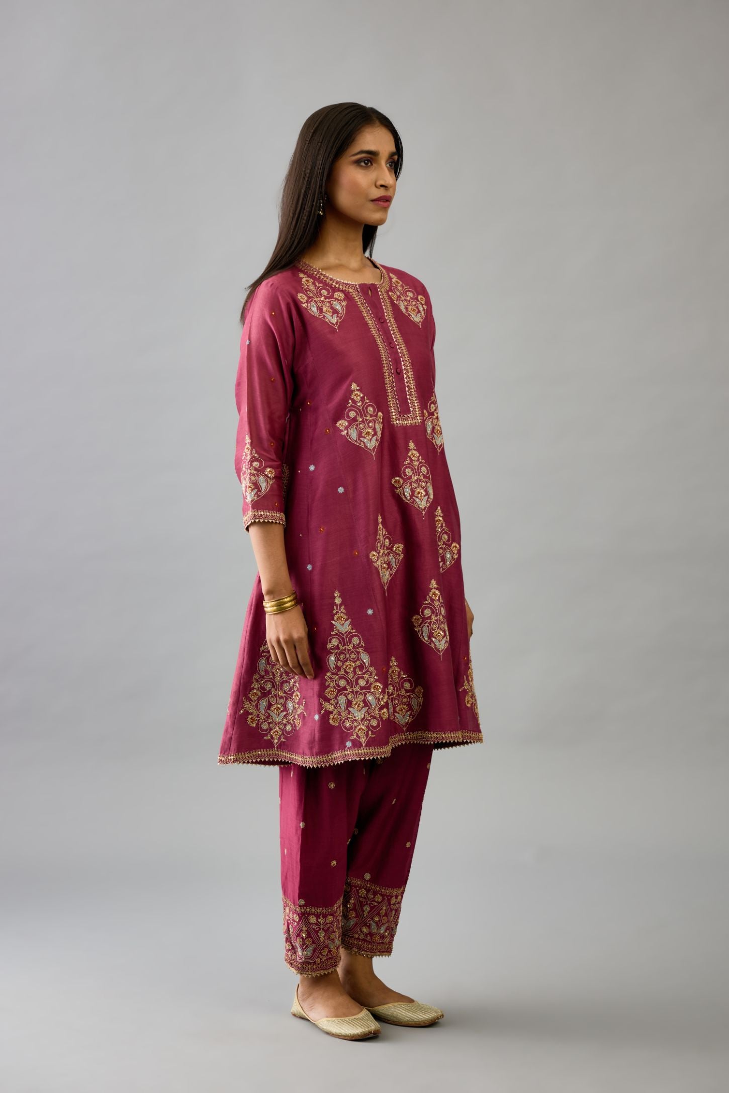 Wine silk chanderi short kalidar phiran style kurta set with dori and contrast silk thread embroidery, highlighted with gold sequins work.