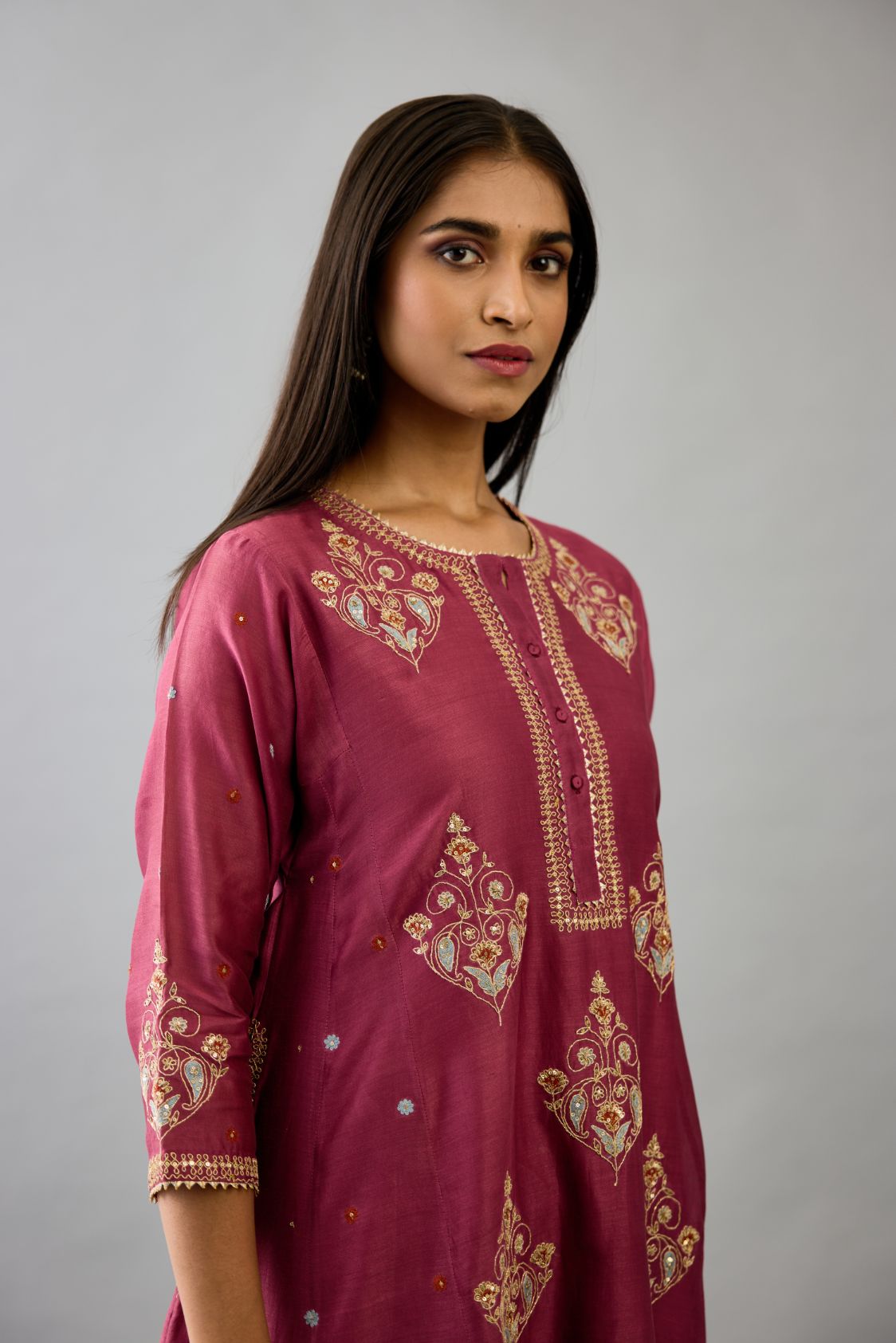 Wine silk chanderi short kalidar phiran style kurta set with dori and contrast silk thread embroidery, highlighted with gold sequins work.