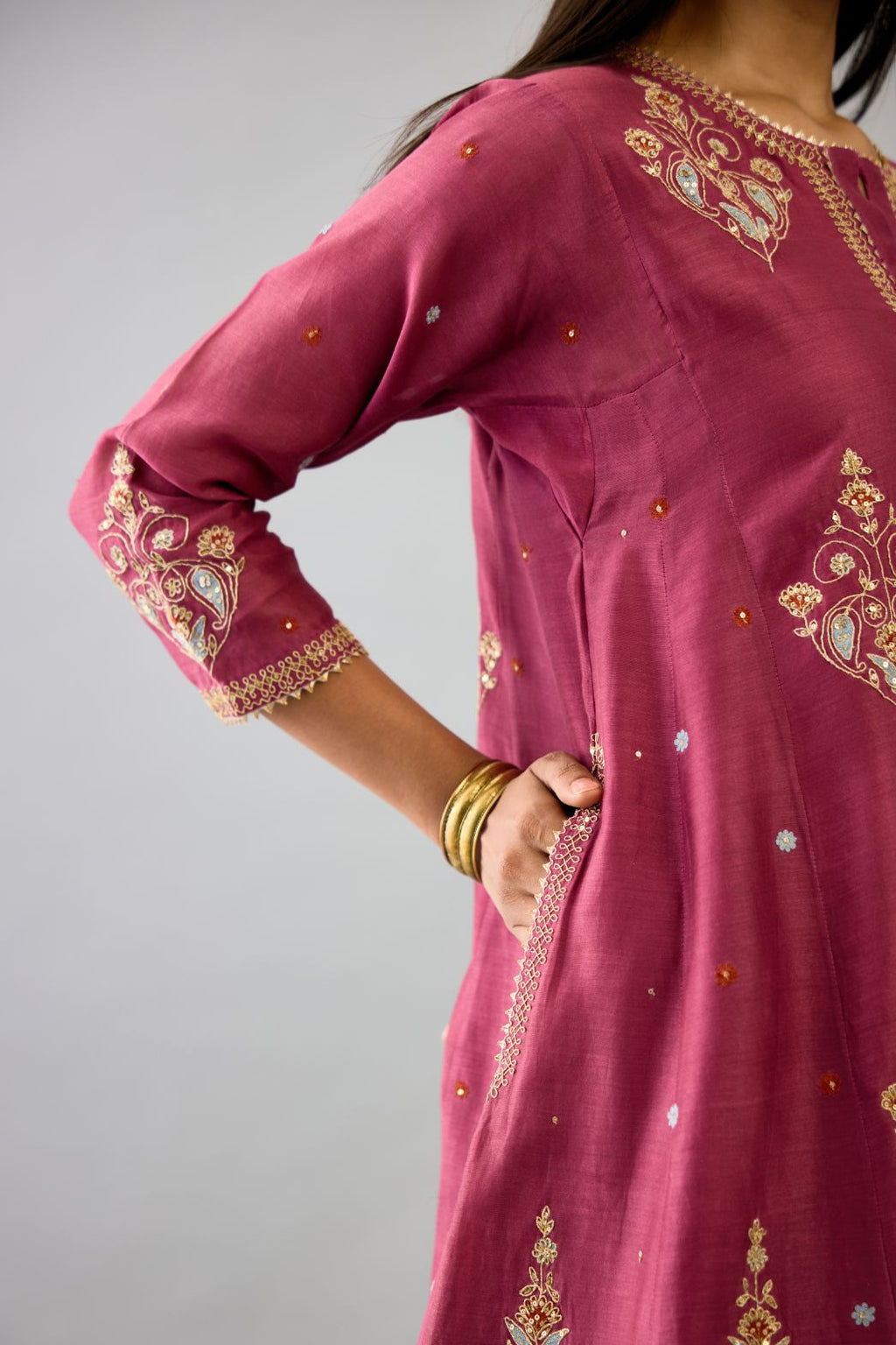 Wine silk chanderi short kalidar phiran style kurta set with dori and contrast silk thread embroidery, highlighted with gold sequins work.