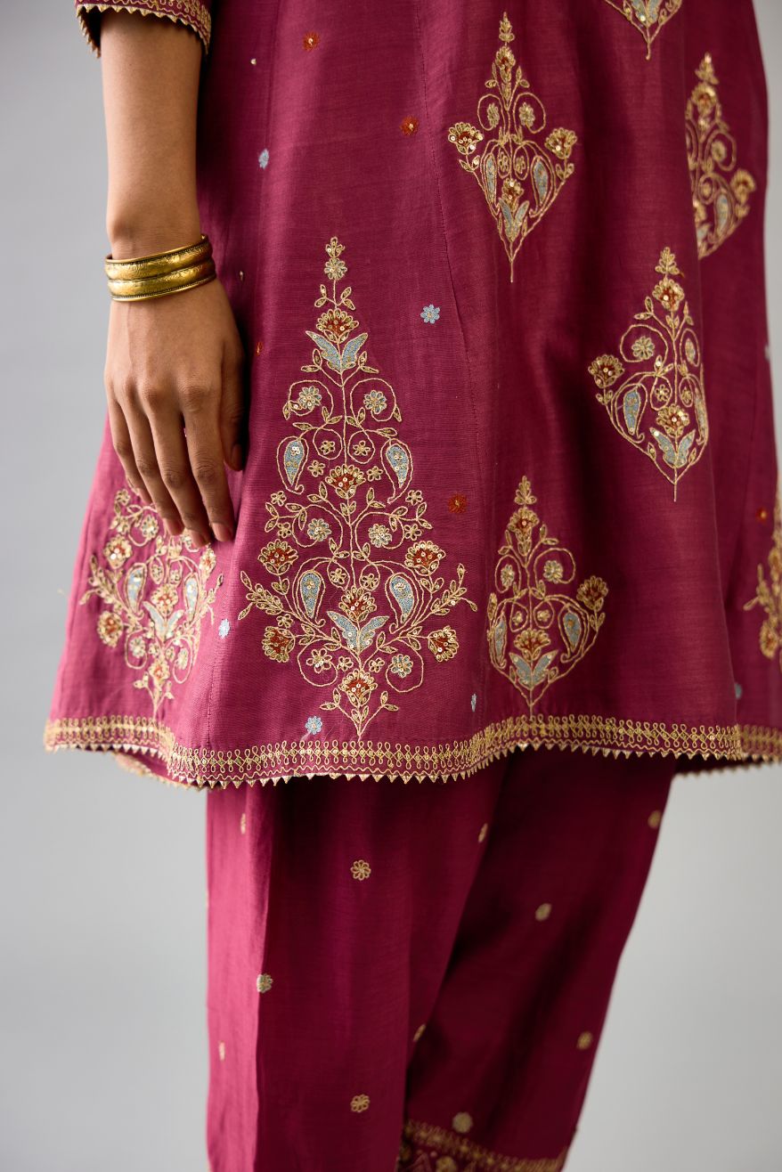 Wine silk chanderi short kalidar phiran style kurta set with dori and contrast silk thread embroidery, highlighted with gold sequins work.