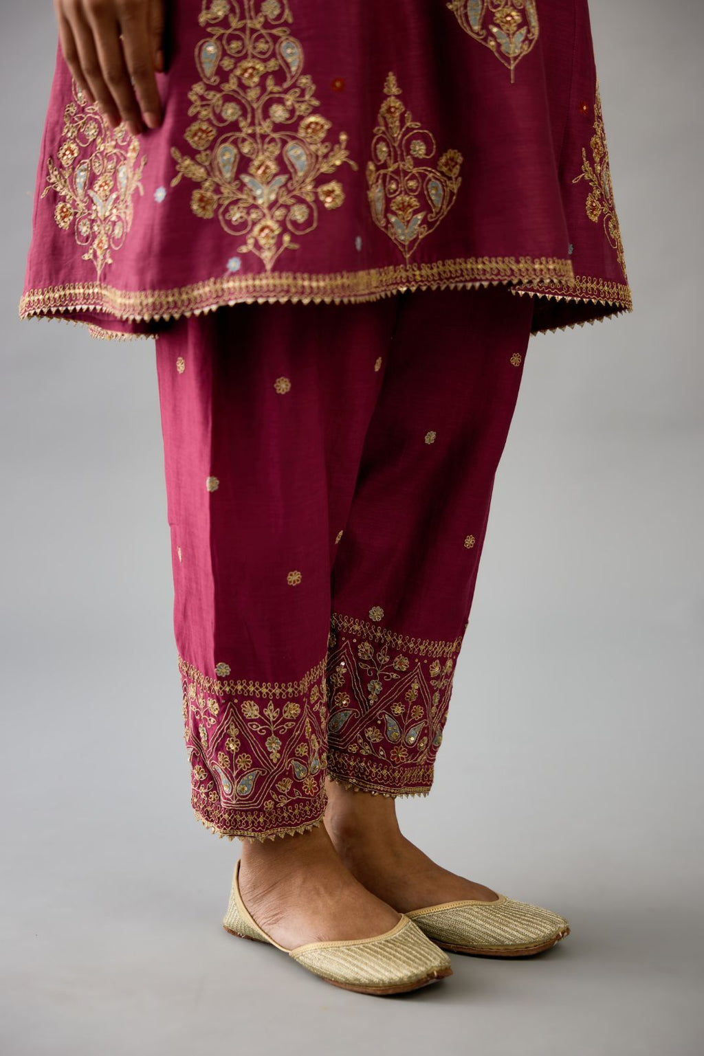 Wine silk chanderi short kalidar phiran style kurta set with dori and contrast silk thread embroidery, highlighted with gold sequins work.