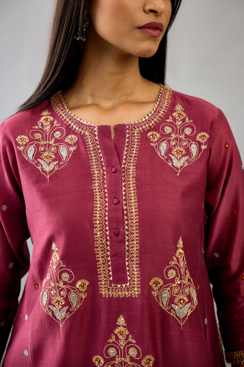 Wine silk chanderi short kalidar phiran style kurta set with dori and contrast silk thread embroidery, highlighted with gold sequins work.