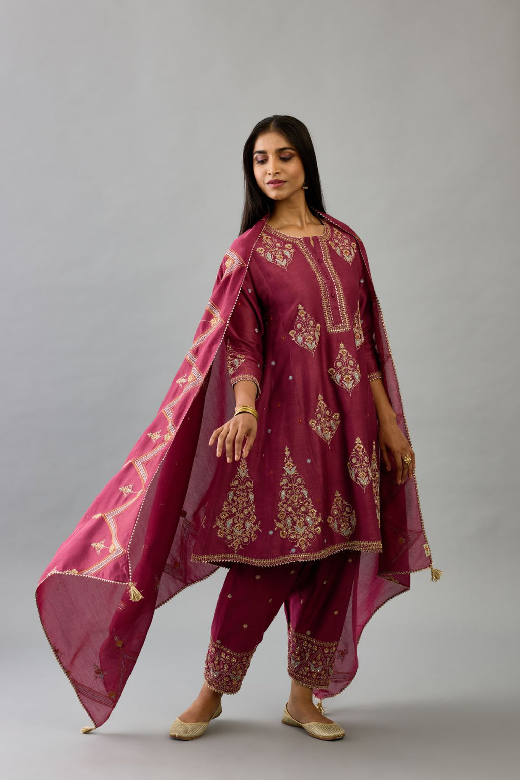 Wine silk chanderi short kalidar phiran style kurta set with dori and contrast silk thread embroidery, highlighted with gold sequins work.