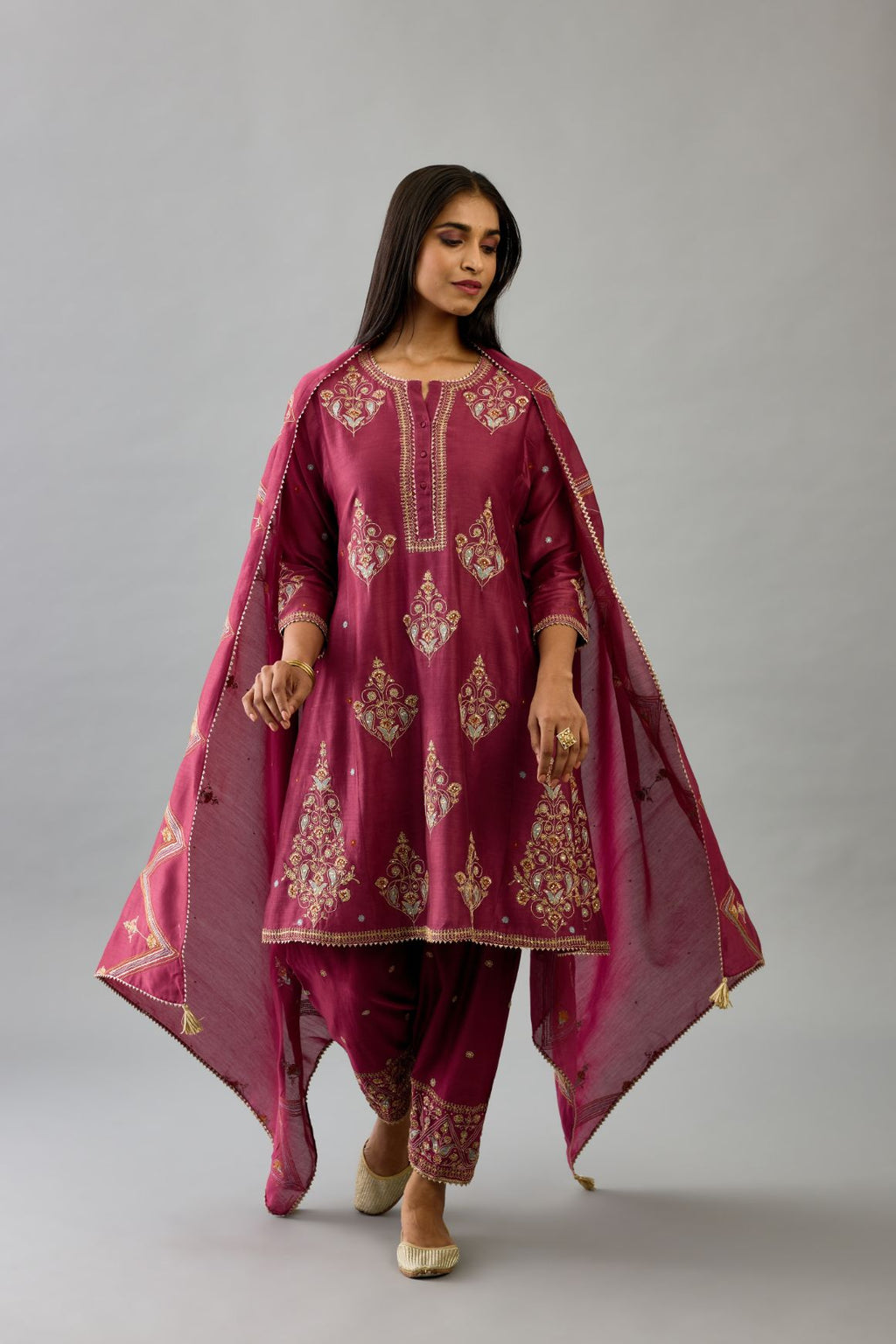 Wine silk chanderi short kalidar phiran style kurta set with dori and contrast silk thread embroidery, highlighted with gold sequins work.