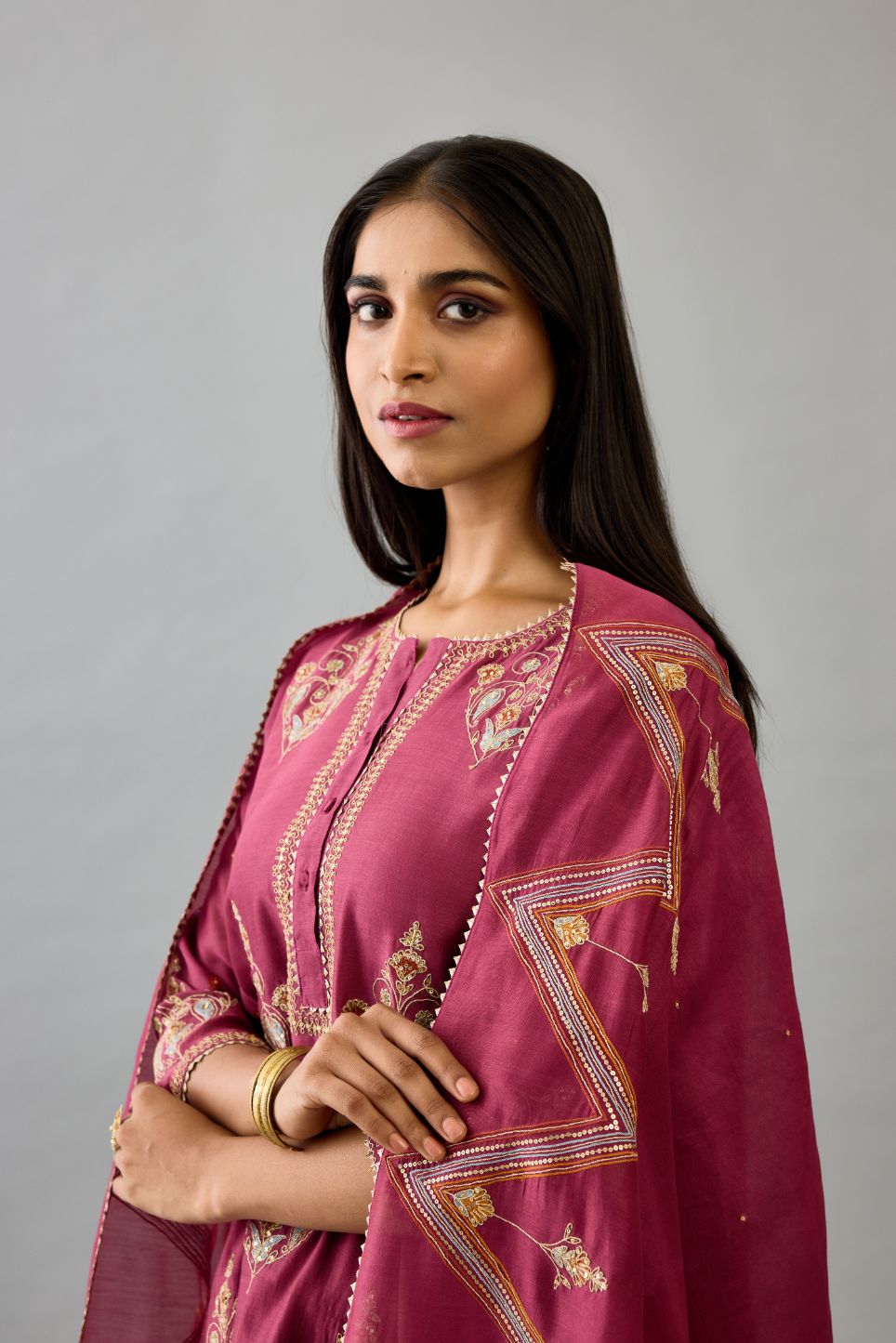 Wine silk chanderi short kalidar phiran style kurta set with dori and contrast silk thread embroidery, highlighted with gold sequins work.