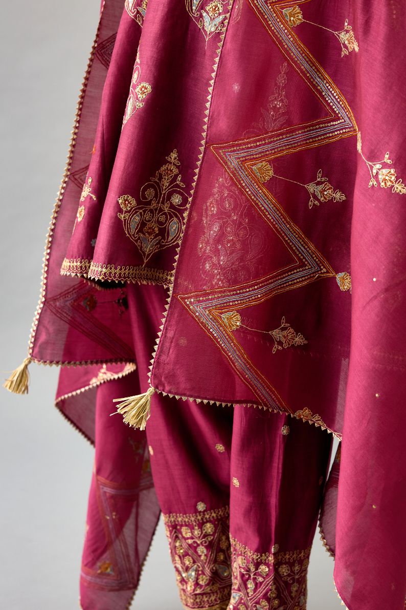 Wine silk chanderi short kalidar phiran style kurta set with dori and contrast silk thread embroidery, highlighted with gold sequins work.