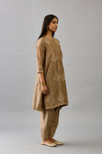 Taupe silk chanderi short kalidar phiran style kurta set with dori and contrast silk thread embroidery, highlighted with gold sequins work.