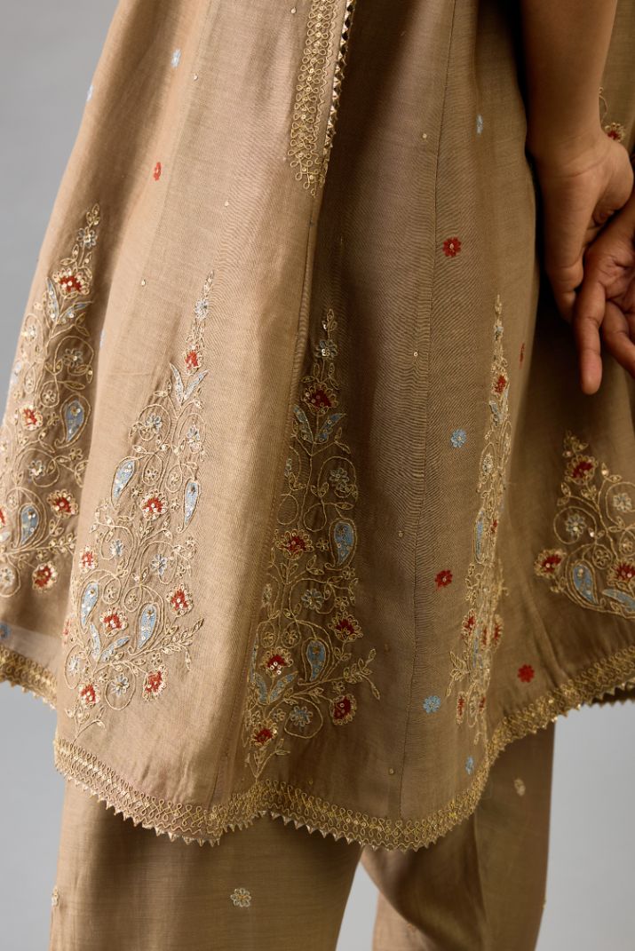 Taupe silk chanderi short kalidar phiran style kurta set with dori and contrast silk thread embroidery, highlighted with gold sequins work.