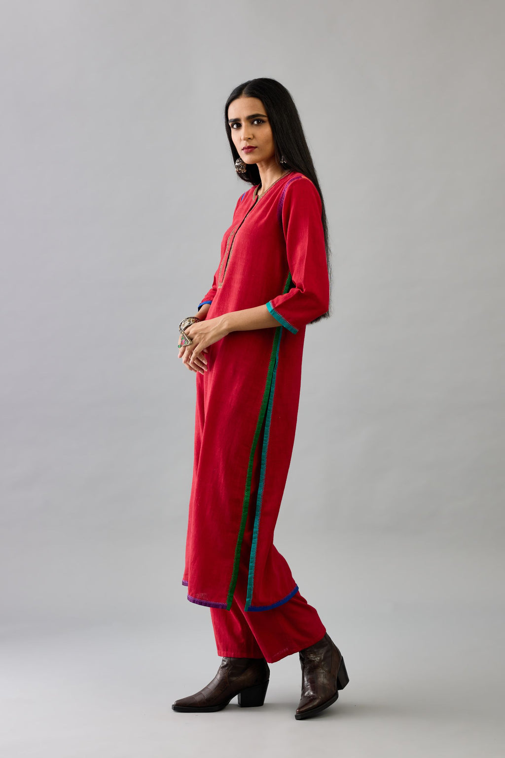 Red handloom cotton straight kurta set with multi colored silk facings and embroidery detail.