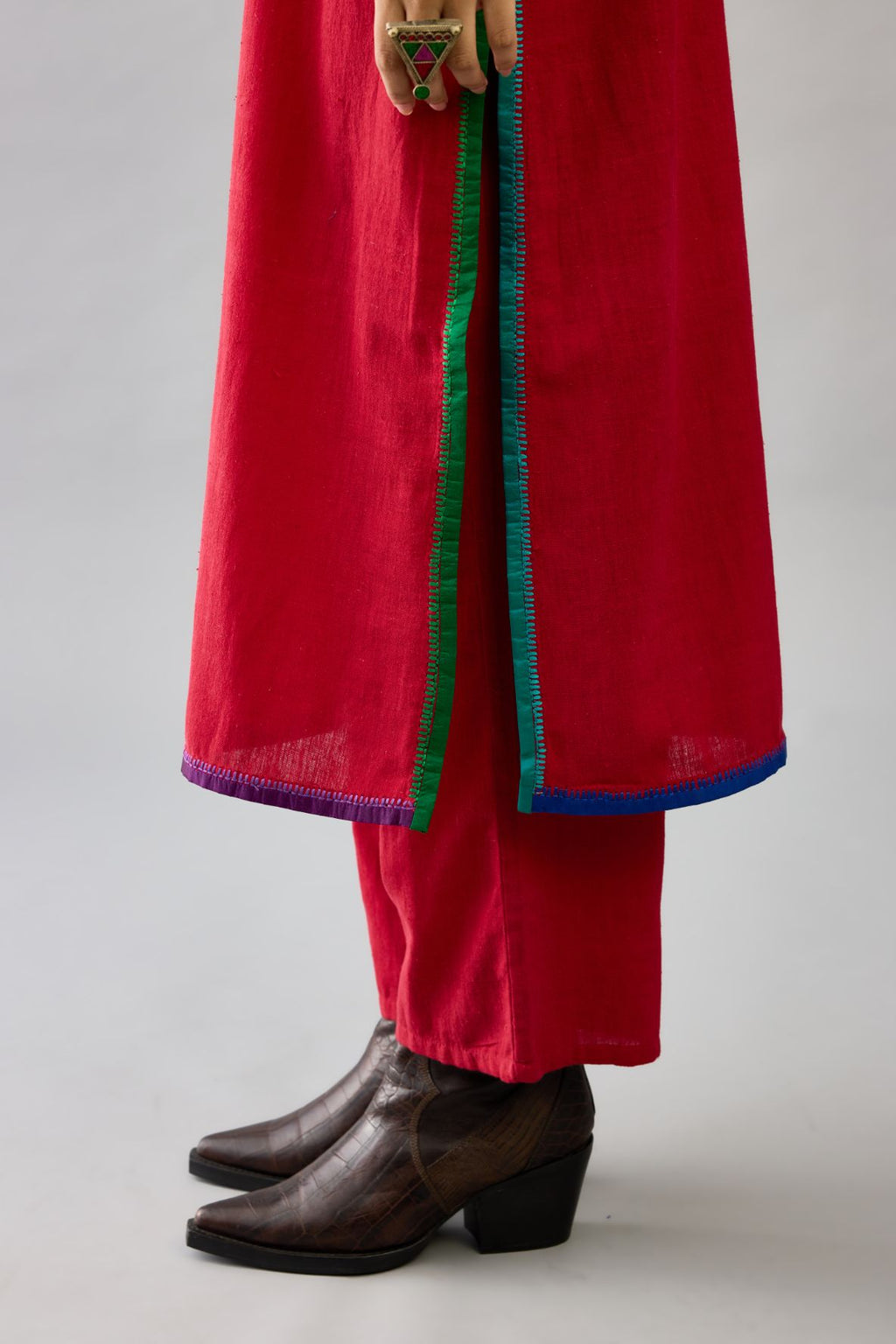 Red handloom cotton straight kurta set with multi colored silk facings and embroidery detail.