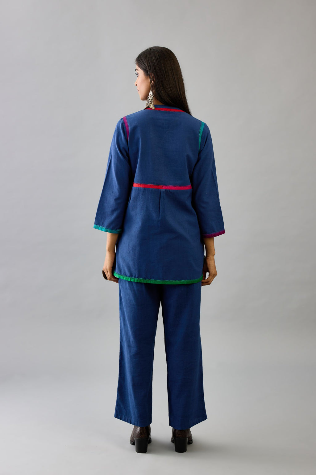 Blue handloom cotton short top with multi colored silk facings and embroidery detail, paired with blue handloom cotton straight pants.
