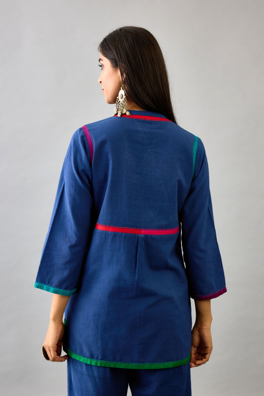 Blue handloom cotton short top with multi colored silk facings and embroidery detail, paired with blue handloom cotton straight pants.