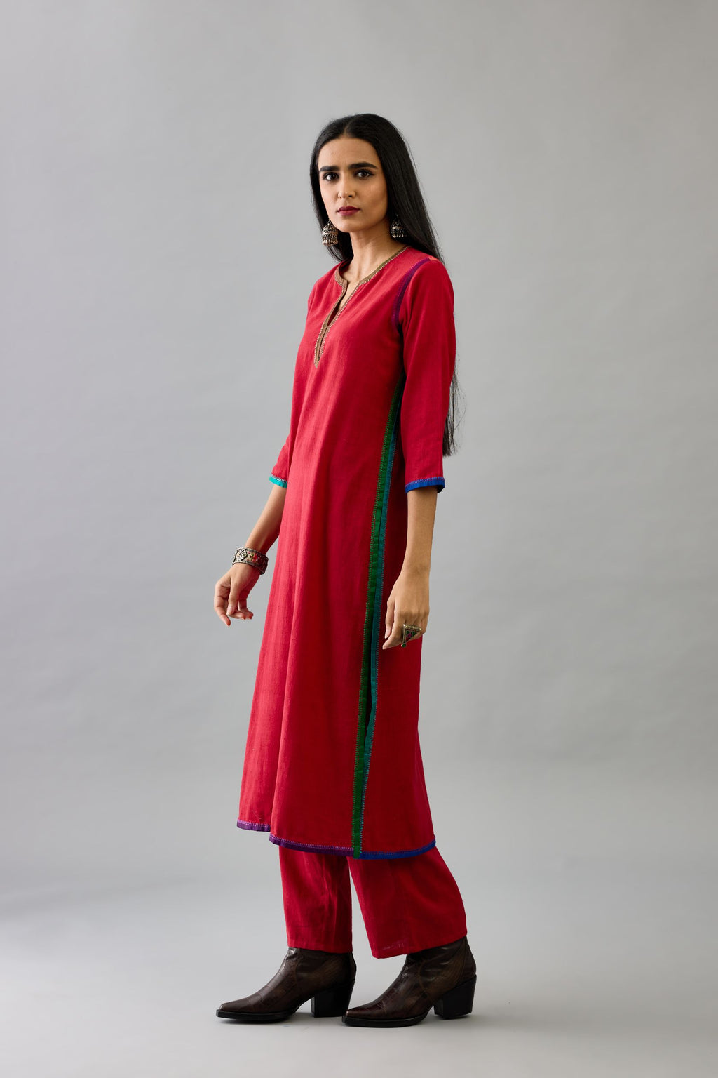 Red handloom cotton straight kurta set with slit neck, multi colored silk facings and embroidery detail.