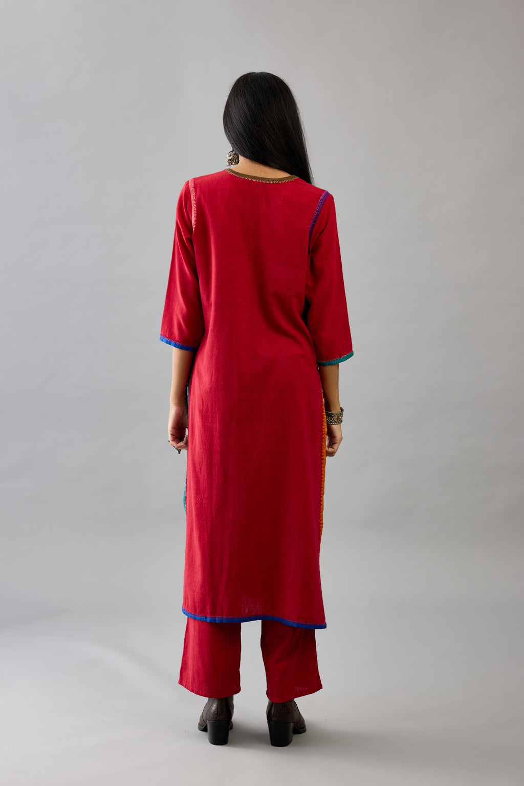 Red handloom cotton straight kurta set with slit neck, multi colored silk facings and embroidery detail.
