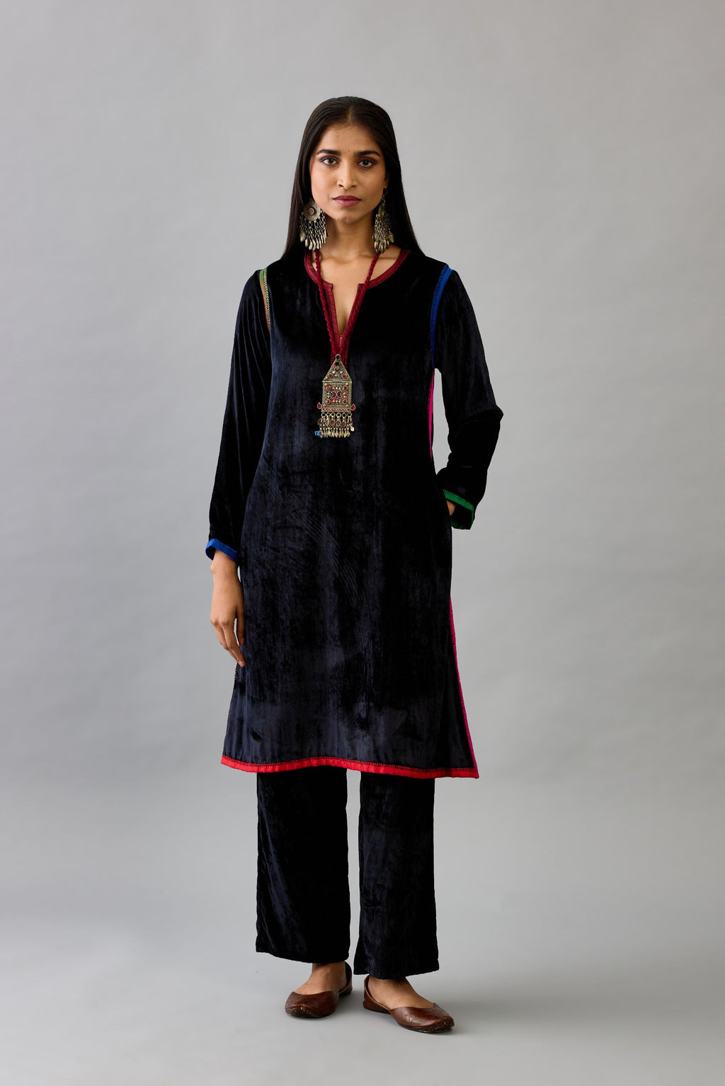 Black silk velvet short A-line kurta set with multi colored silk facing and embroidery.