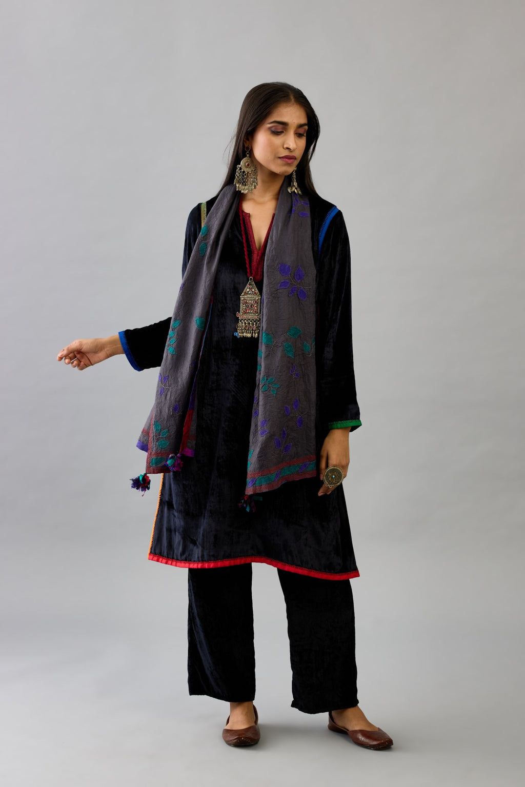 Black silk velvet short A-line kurta set with multi colored silk facing and embroidery.