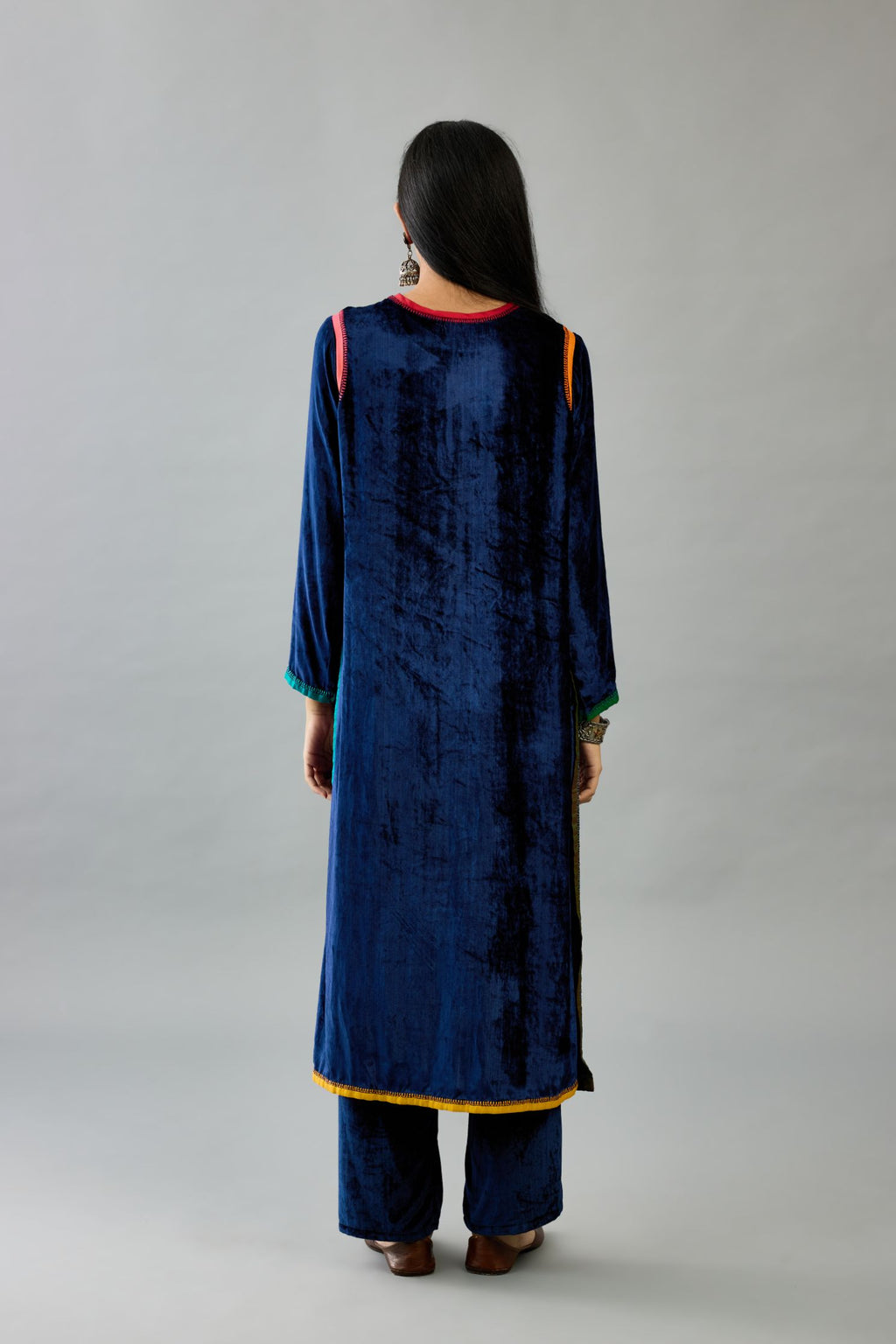 Blue silk velvet straight kurta set with multi colored silk facing and embroidery details.