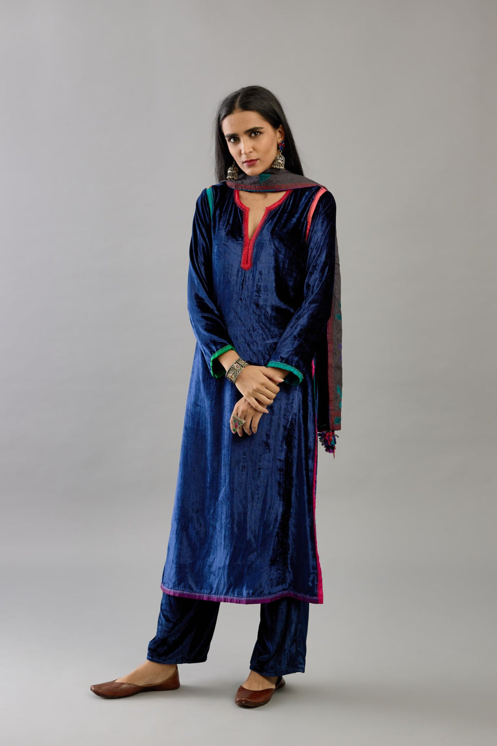 Blue silk velvet straight kurta set with multi colored silk facing and embroidery details.