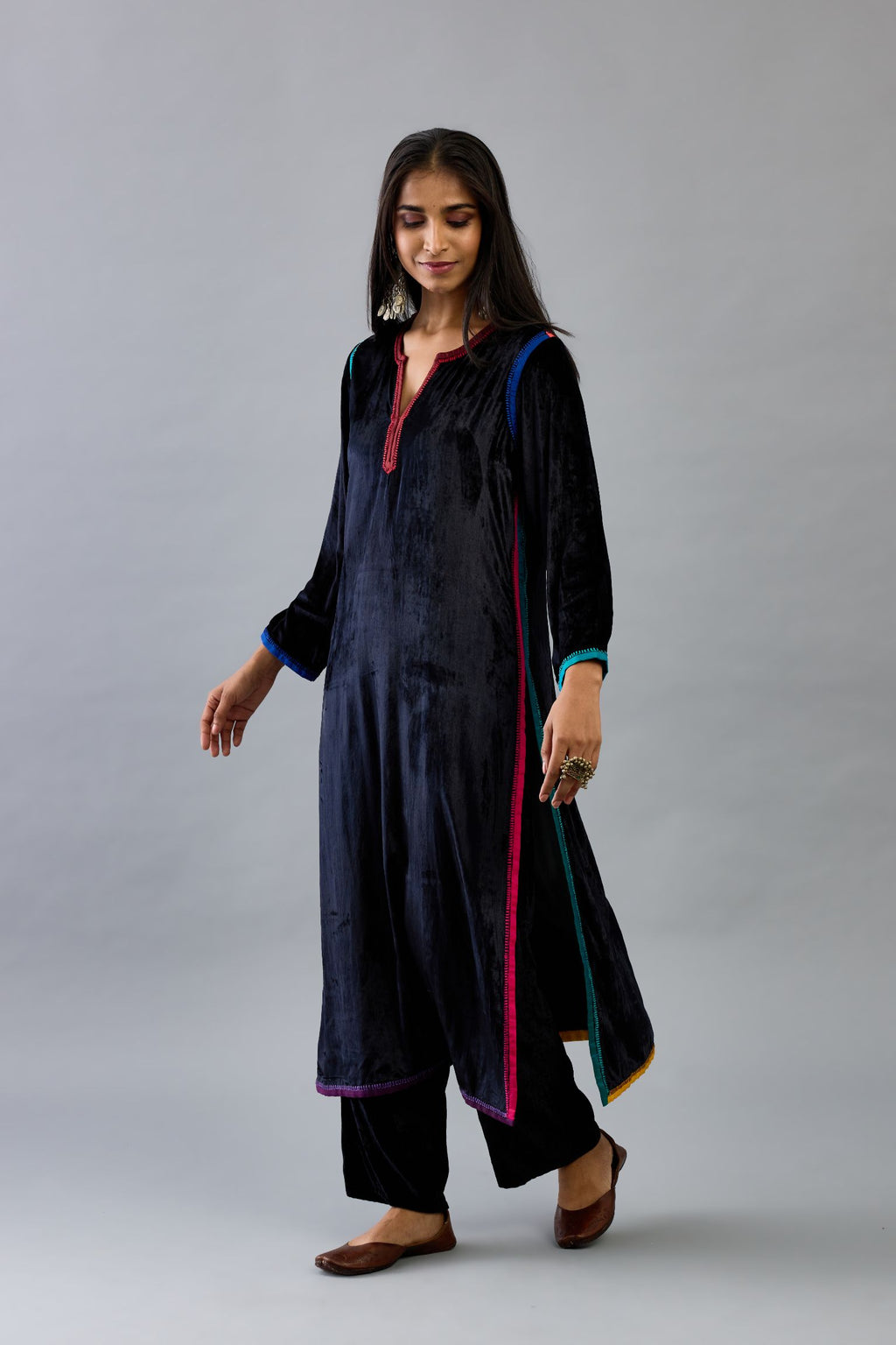 Black silk velvet straight kurta set with multi colored silk facing and embroidery details.