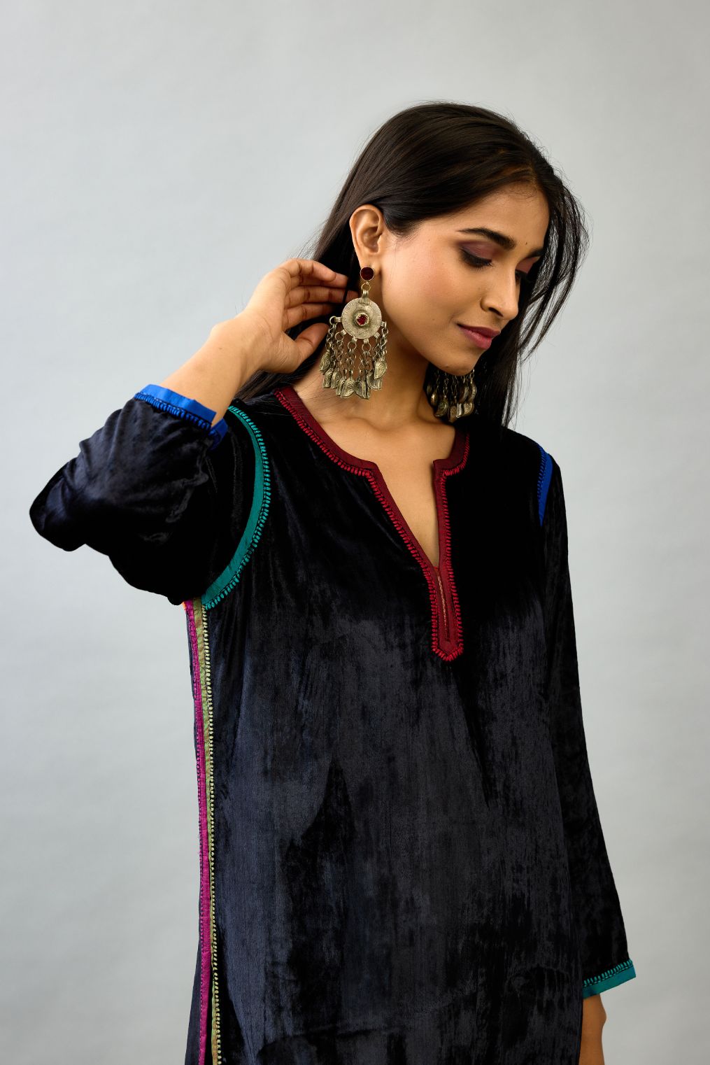 Black silk velvet straight kurta set with multi colored silk facing and embroidery details.