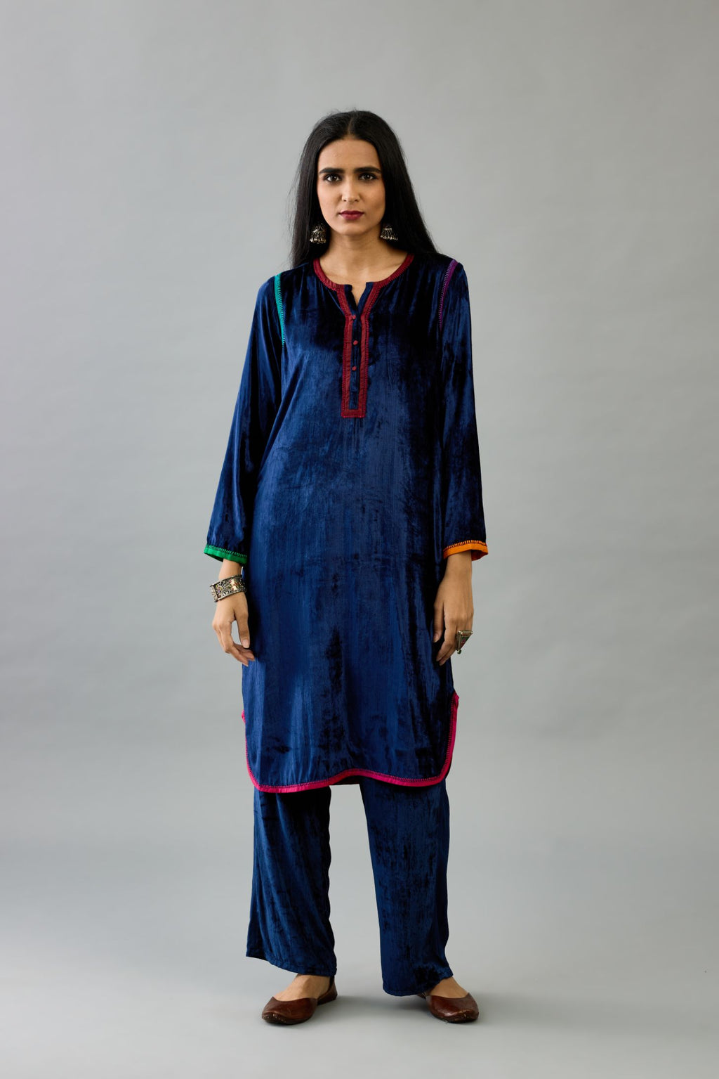 Blue silk velvet short kurta set with round hem and multi colored silk facing, highlighted with embroidery.