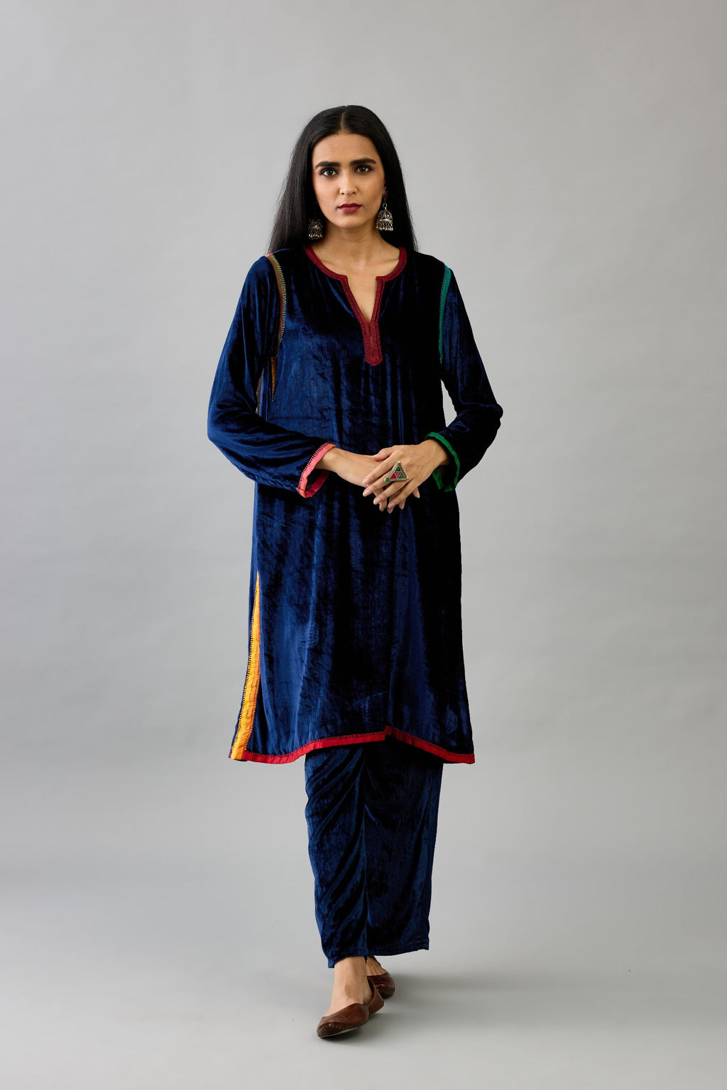 Blue silk velvet short A-line kurta set with multi colored silk facing and embroidery.