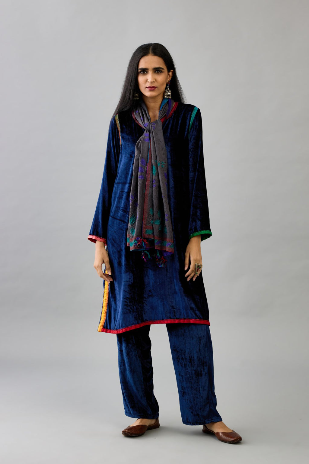 Blue silk velvet short A-line kurta set with multi colored silk facing and embroidery.
