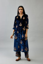 Blue silk velvet straight kurta set with zari, dori and contrast silk thread embroidered bootas, highlighted with gold sequins work.