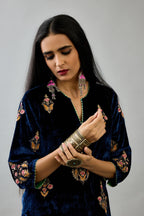 Blue silk velvet straight kurta set with zari, dori and contrast silk thread embroidered bootas, highlighted with gold sequins work.