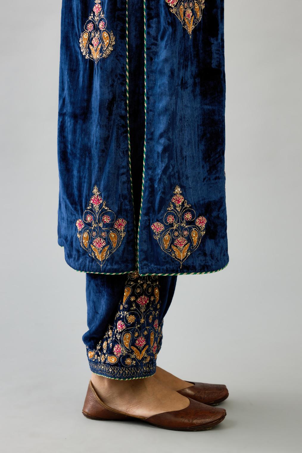 Blue silk velvet straight kurta set with zari, dori and contrast silk thread embroidered bootas, highlighted with gold sequins work.