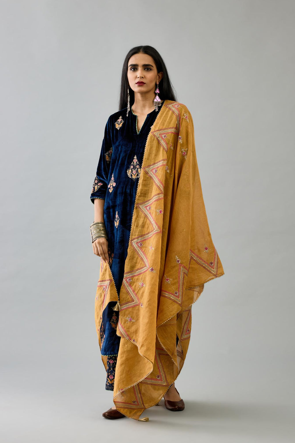 Golden yellow tissue chanderi dupatta in chevron pattern embroidery with contrast silk thread and dori at the sides.