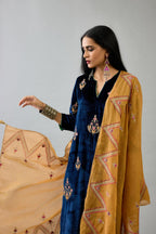 Blue silk velvet straight kurta set with zari, dori and contrast silk thread embroidered bootas, highlighted with gold sequins work.