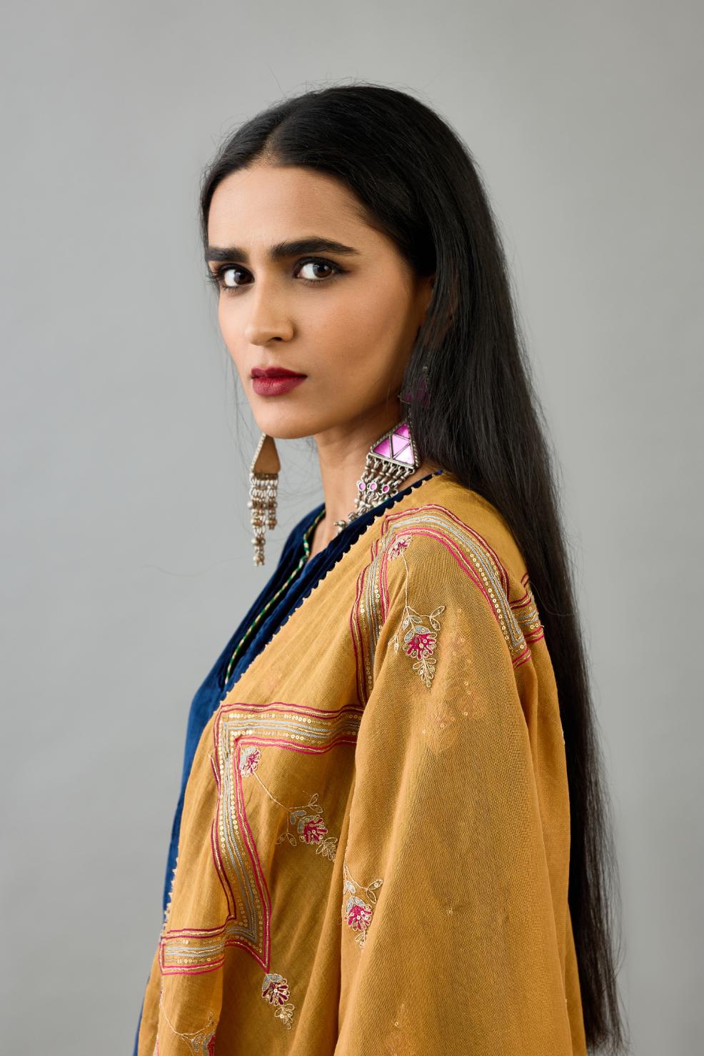 Golden yellow tissue chanderi dupatta in chevron pattern embroidery with contrast silk thread and dori at the sides.