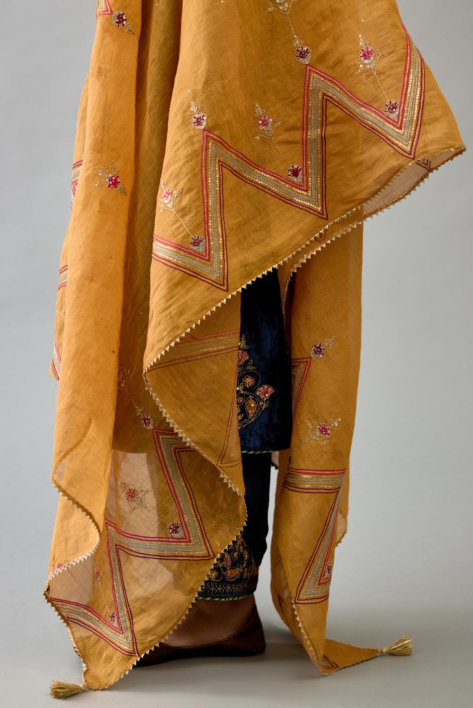 Golden yellow tissue chanderi dupatta in chevron pattern embroidery with contrast silk thread and dori at the sides.