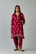 Fuchsia silk velvet A-line short kurta set with dori and contrast silk thread embroidery, highlighted with gold sequins work.