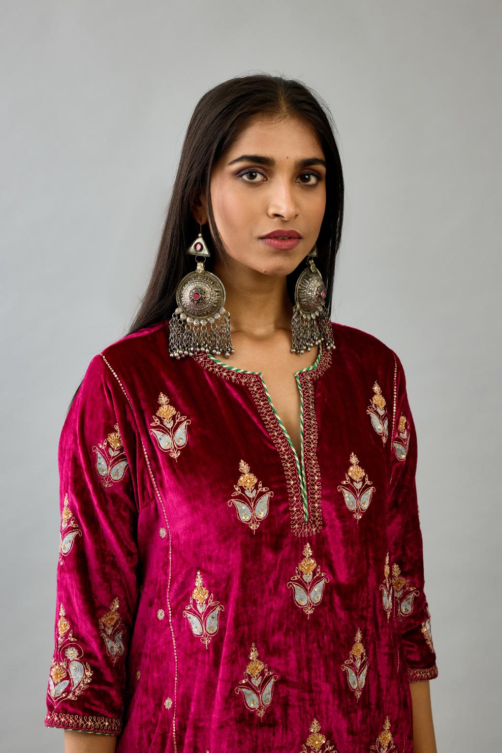 Fuchsia silk velvet A-line short kurta set with dori and contrast silk thread embroidery, highlighted with gold sequins work.