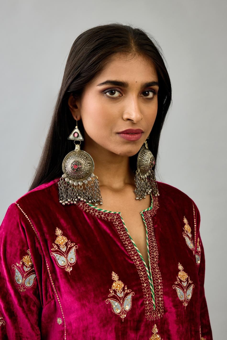 Fuchsia silk velvet A-line short kurta set with dori and contrast silk thread embroidery, highlighted with gold sequins work.